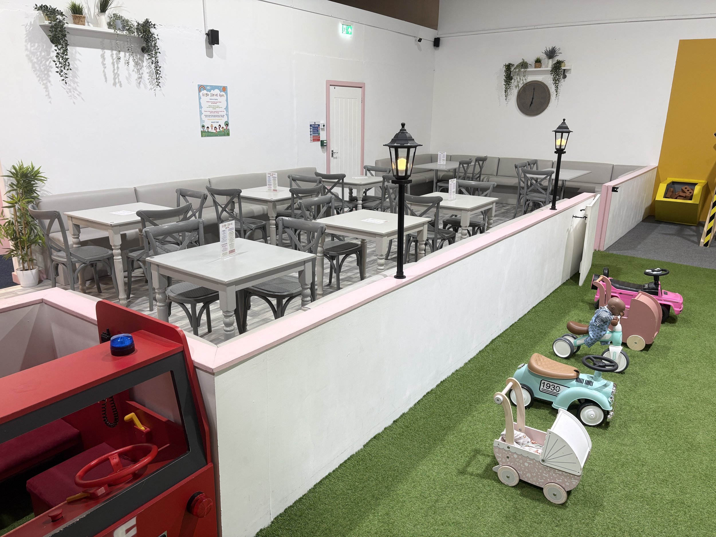 Family seating area in the Giggle Street café overlooking the play street